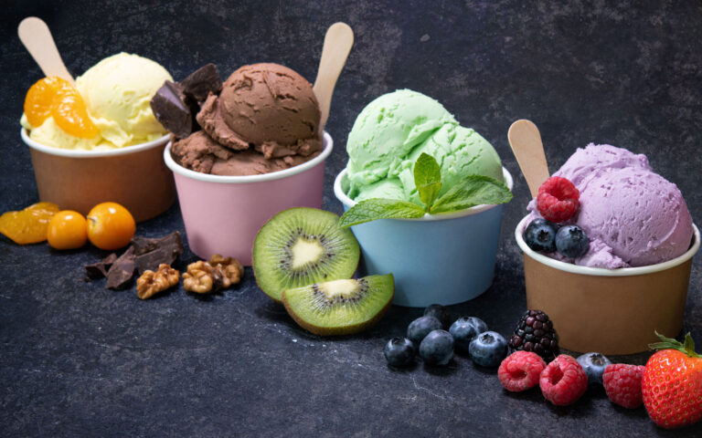 Various colorful ice cream in paper cup on dark rustic background Various colorful ice cream in paper cup on dark rustic background