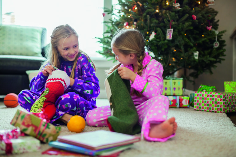 Girls opening Christmas stockings Girls opening Christmas stockings