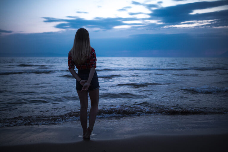 Silhouette of young woman at the sea at night Silhouette of young woman at the sea at night