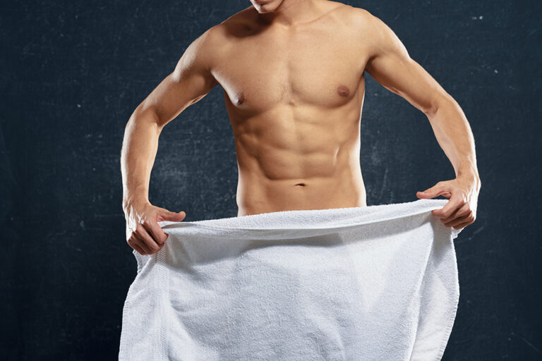 A man with a naked torso holds a towel in his hands ; Shutterstock ID 1299235177 A man with a naked torso holds a towel in his hands ; Shutterstock ID 1299235177
