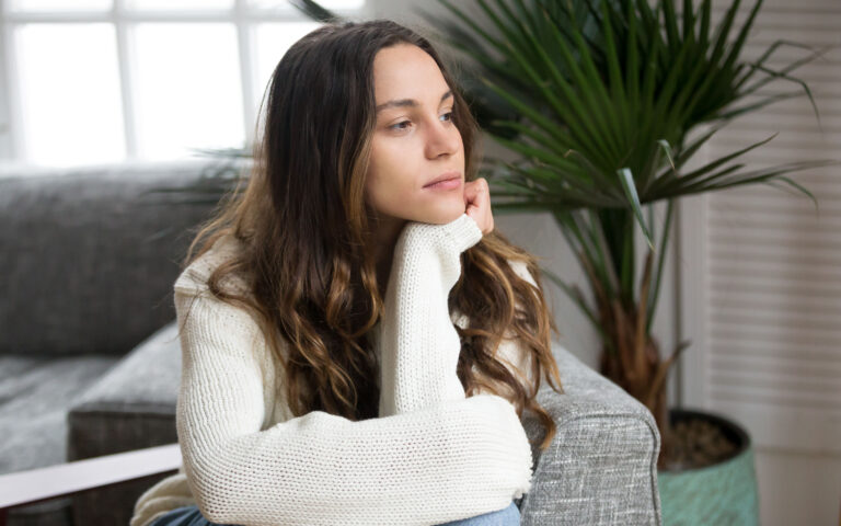 Pensive thoughtful young girl feeling lonely looking away lost in thoughts, sad depressed teenager spending time alone at home in silence, melancholic meditative serious woman thinking about problems; Shutterstock ID 1100199122; Pubblicazione: sld online