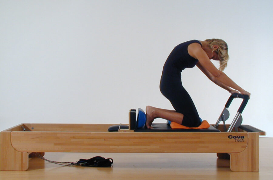 Pilates: gambe, glutei e addominali si tonificano sul Reformer con il Knee stretch