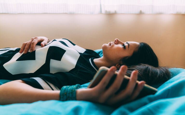 Young woman feeling worried after checking COVID-19 symptoms online and staying home for safety Young woman feeling worried after checking COVID-19 symptoms online and staying home for safety