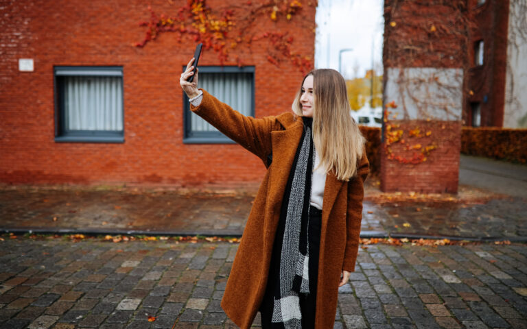 Shot of a young woman taking a selfie while spending a day in the city