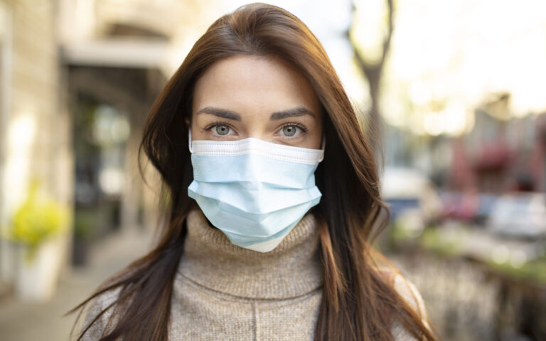 Portrait of an attractive young woman wearing a face mask to protect herself and others from airborne viruses while being outdoors in the city Portrait of an attractive young woman wearing a face mask to protect herself and others from airborne viruses while being outdoors in the city