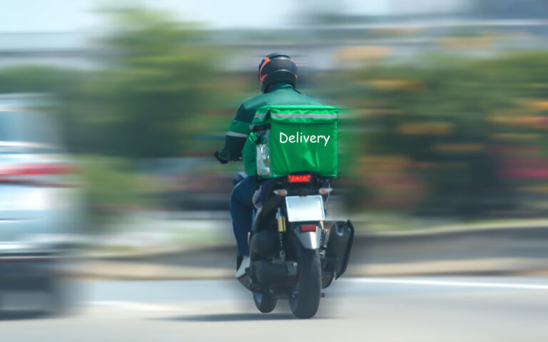 Food delivery drivers are driving to deliver products to customers who order online. Impact of epidemics