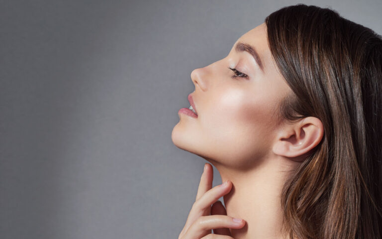 Studio shot of a beautiful young woman posing against a gray background