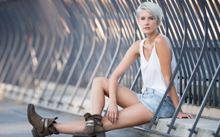 Beautiful blond woman with stylisch hair wearing leisure urban fashion. Hot Pants, boots and tank top. Beautiful blond woman with stylisch hair wearing leisure urban fashion. Hot Pants, boots and tank top.
