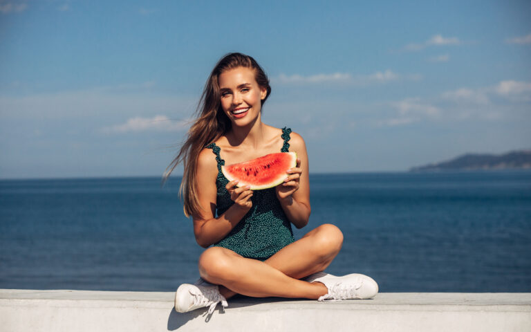 Beautiful girl sitting near the sea Beautiful girl sitting near the sea