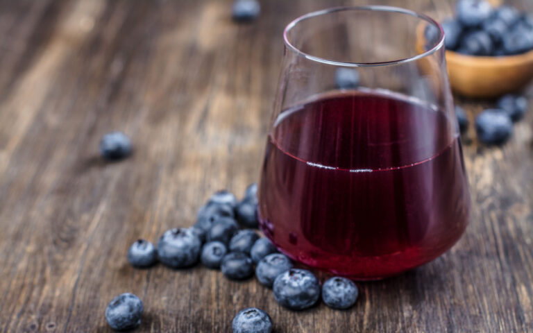 Fresh blueberry juice with berries on wooden background Fresh blueberry juice with berries on wooden background