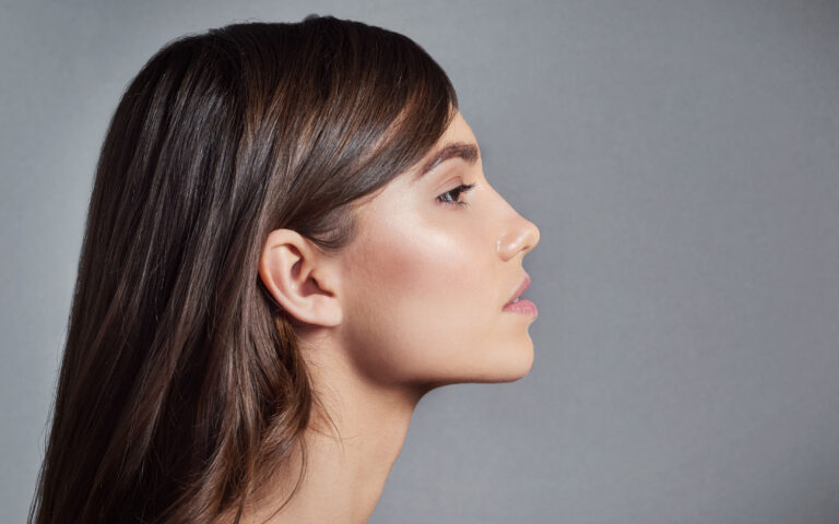 Studio shot of a beautiful young woman posing against a gray background Studio shot of a beautiful young woman posing against a gray background