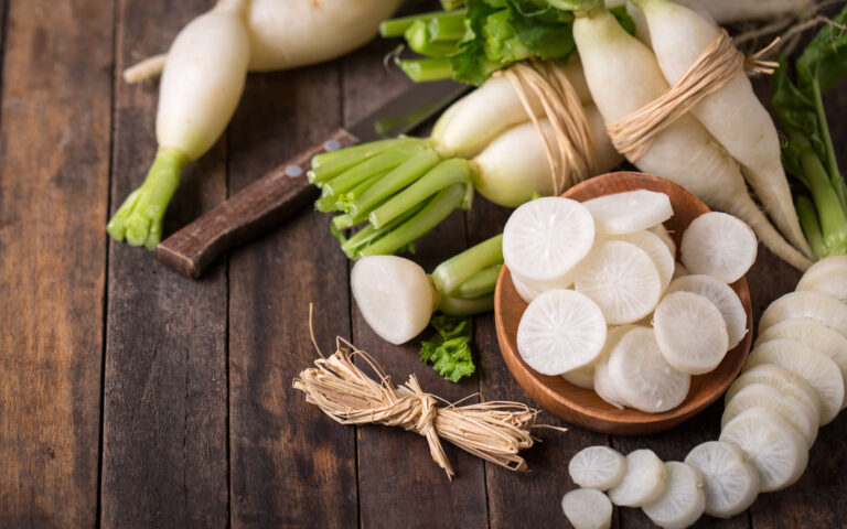 White organic radishes on the wooden table