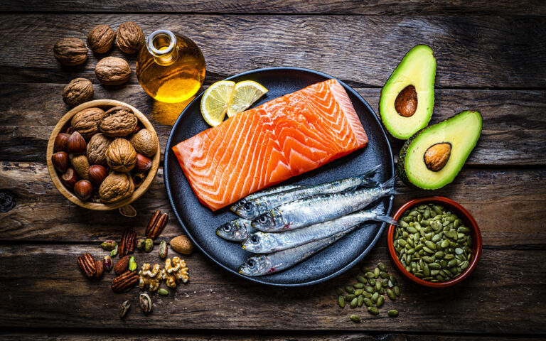 Healthy eating for well balanced diet and heart care: overhead view of a group of food rich in healthy fats shot on rustic wooden table. The composition includes salmon, sardines, avocado, extra virgin olive oil, nuts and seeds like walnut, almonds, pecan, hazelnuts, pistachio and pumpkin seeds. High resolution 42Mp studio digital capture taken with SONY A7rII and Zeiss Batis 40mm F2.0 CF lens Healthy eating for well balanced diet and heart care: overhead view of a group of food rich in healthy fats shot on rustic wooden table. The composition includes salmon, sardines, avocado, extra virgin olive oil, nuts and seeds like walnut, almonds, pecan, hazelnuts, pistachio and pumpkin seeds. High resolution 42Mp studio digital capture taken with SONY A7rII and Zeiss Batis 40mm F2.0 CF lens