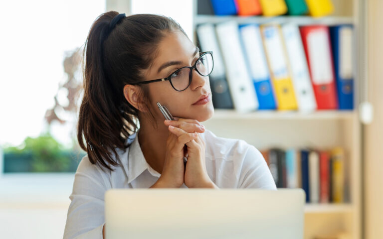 Woman looking thoughtful in a modern office