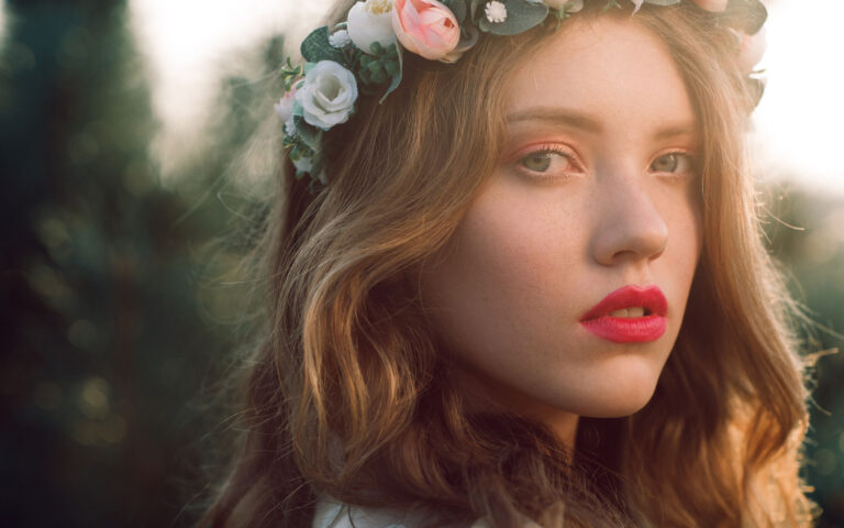 Young casual bride in wreath close-up portrait, free space. Beautiful fashion woman with perfect makeup posing outdoor in sunset light, blurred pine forest background Young casual bride in wreath close-up portrait, free space. Beautiful fashion woman with perfect makeup posing outdoor in sunset light, blurred pine forest background