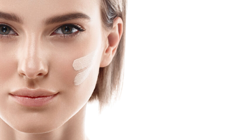 Skin tone cream lines on woman face. Beautiful woman portrait beauty skin healthy and perfect makeup. Studio shot. Isolated on white. Skin tone cream lines on woman face. Beautiful woman portrait beauty skin healthy and perfect makeup. Studio shot. Isolated on white.