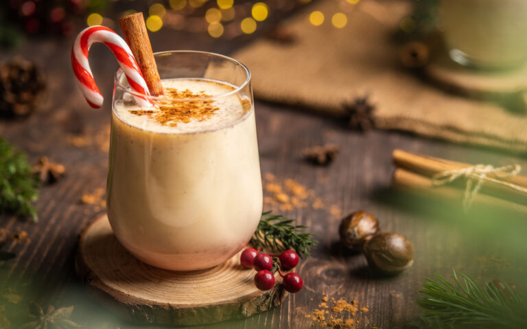 Eggnog with spicy cinnamon.Christmas and winter holidays,Cozy cocktail with cinnamon and candy cane,Traditional Christmas drink with grated nutmeg and cinnamon,Homemade Holiday drink