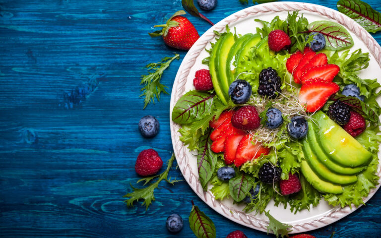 Mixed salad leaves with berries, avocado and honey-mustard dressing