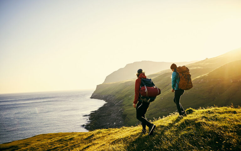 Shot of a young couple hiking through the mountains