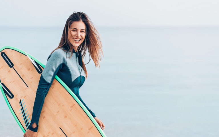 Surfer girl walking on the beach Surfer girl walking on the beach