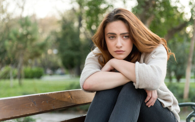 Thoughtful woman in the park