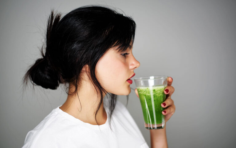 Young woman drinking healthy detox Young woman drinking healthy detox