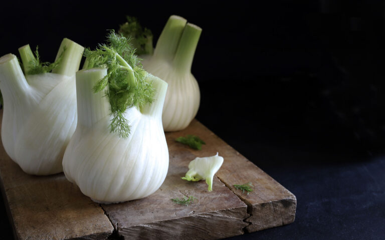 Fresh fennel on a wooden cutting board. Vegetable food.