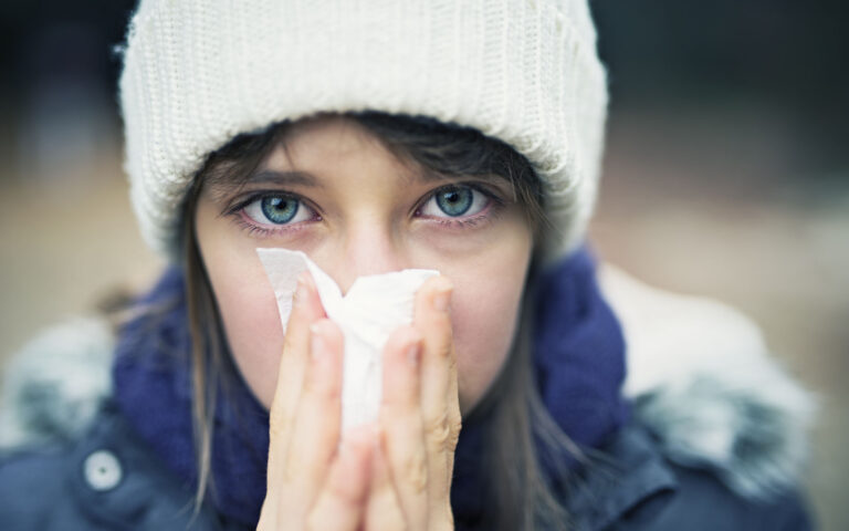 Little girl aged 10 cleaning her nose in autumn. The girl is not feeling well and looks quite pale and sick. Little girl aged 10 cleaning her nose in autumn. The girl is not feeling well and looks quite pale and sick.
