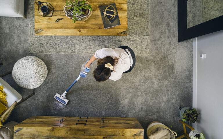 A professional housecleaner at work cleaning a home. A professional housecleaner at work cleaning a home.