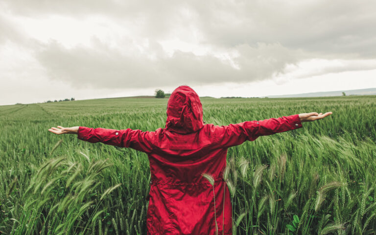 Woman wearing red raincoat out in the rain Woman wearing red raincoat out in the rain