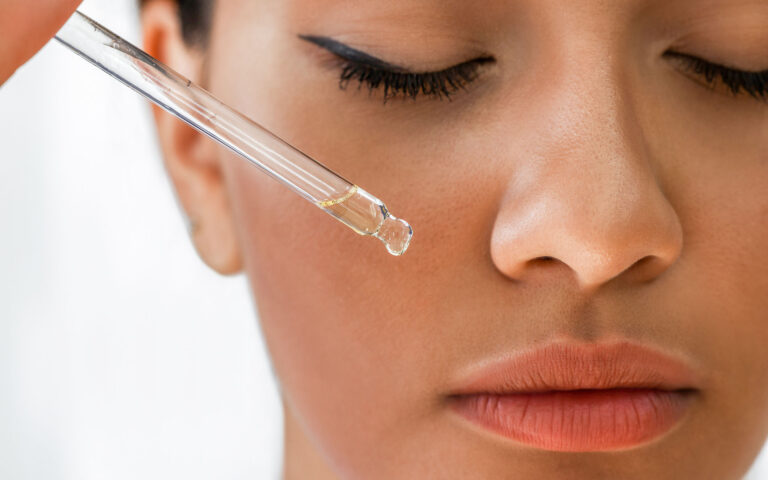 Woman applying essential oil Woman applying essential oil