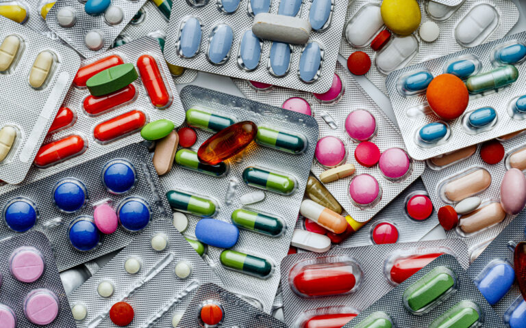 Health themes: Background of a large group of assorted capsules, pills and blisters. Drug abuse. Health themes: Background of a large group of assorted capsules, pills and blisters. Drug abuse.