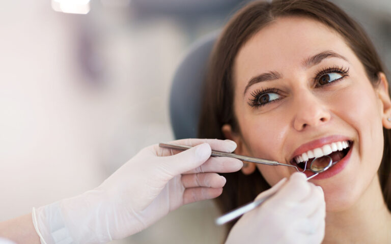 Woman having teeth examined at dentists