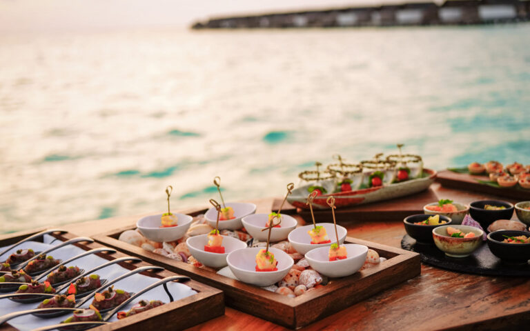 Elegant selection of gourmet tapas by the sea in the sunset