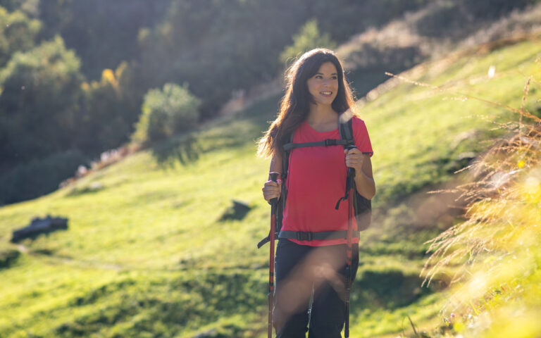 Beautiful young woman hiking on Italian Alps mountains